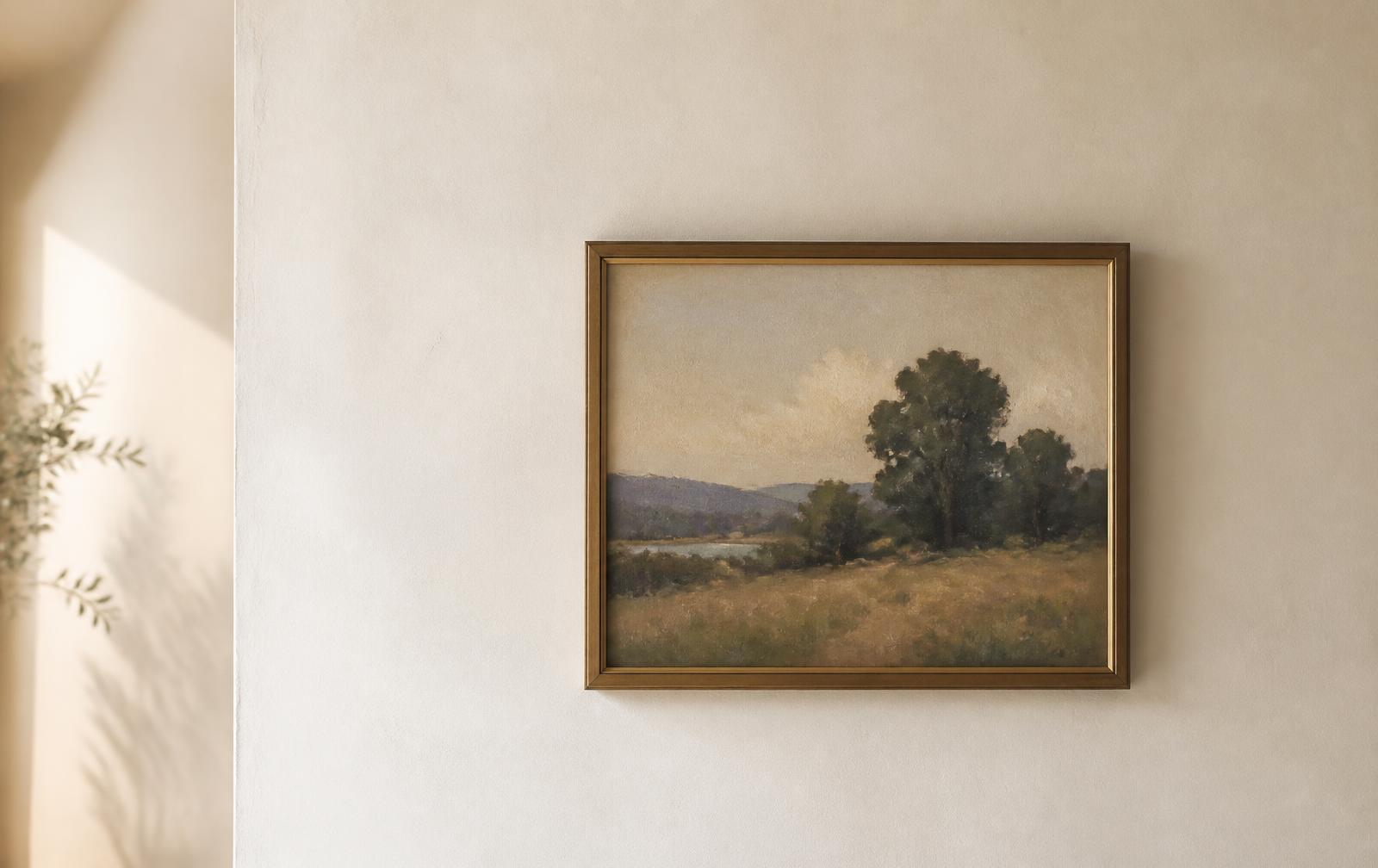 A single framed painting hanging on a plain wall in daylight